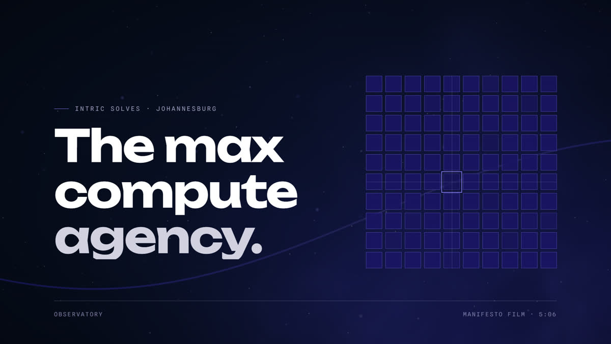 A frame from the film: the words 'The max compute agency' beside a grid of compute cells lighting up